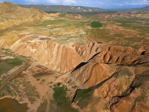 Panorama with striking earth-coloured rock formations and green fields under a blue sky, aerial view, mountains on D70 and D80, Tuzluca, Igdir province, Iğdır, Eastern Anatolia, Anatolia, Turkey
