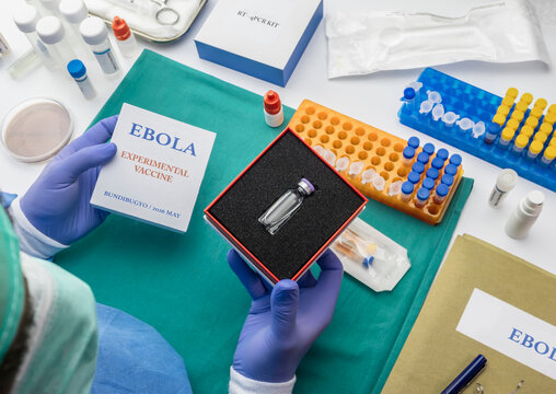 A scientist holds a prototype Ebola vaccine in a laboratory, a conceptual studio recreation.