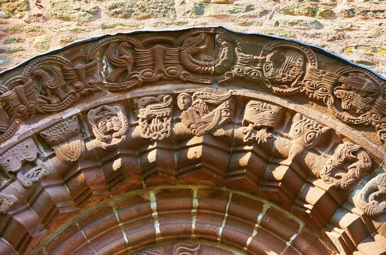 Norman Romanesque relief sculptures of dragons and mythical creatures, circa 1140, South doorway of Church of St Mary and St David, Kilpeck, Herefordshire, England, United Kingdom