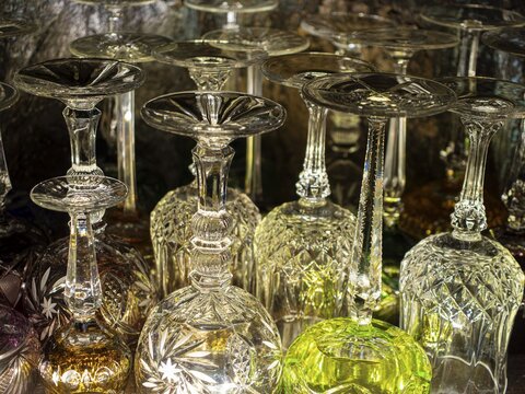 Lead crystal glasses, wine glasses, champagne glasses, colourful in old display case cabinet