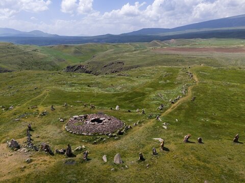 Hilly landscape with stone circle and wide sky with clouds in the background, aerial view, megaliths, Zorats Karer, Zorakarer, Karahundsch, Bronze Age burial ground, Sisian, Sissian, Syunik province, historically Sangesur, Armenia