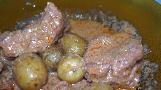 Beef Rendang, or slow-cooked beef rendang, is served on a plate with bright lighting.

