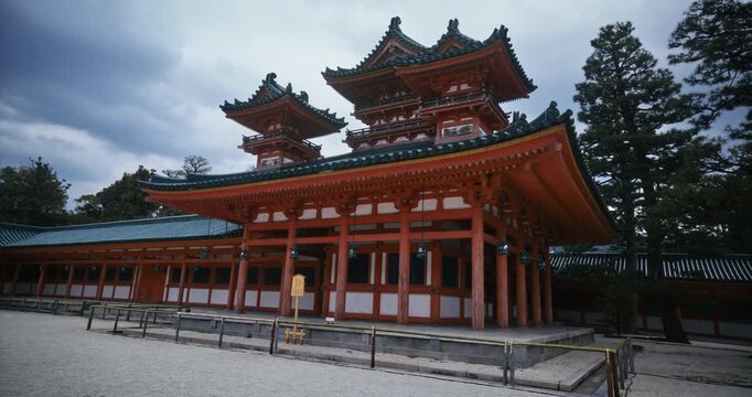 Slow, low steady cam shot in on ancient Japanese temple with overcast sky