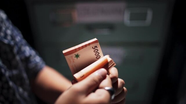 Close Up Hand Holding Indonesian 500 Thousand Rupiah Banknotes