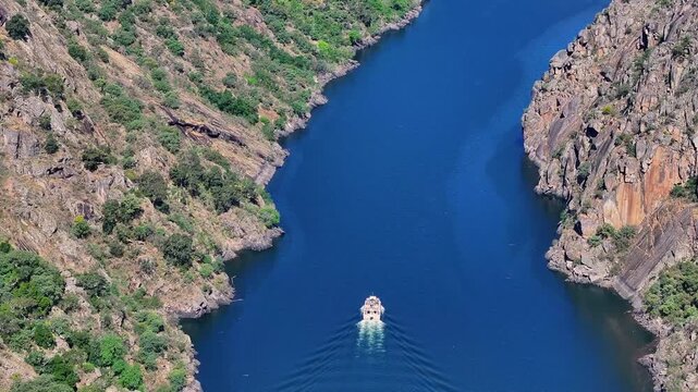 Motor Boat Across The Sil River From Cadeiras Viewpoint In Sober, Spain. Aerial Tilt-up Shot