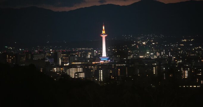 Beautiful city lights in Japanese city at dusk - high, wide shot