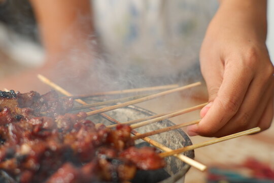 Indonesian sate ayam barbecue cooking process close-up view