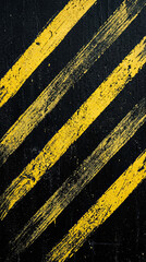 Fototapeta premium Close-up of worn black and yellow diagonal hazard stripes on industrial surface, distressed floor texture, grunge background, caution markings, rugged urban design.