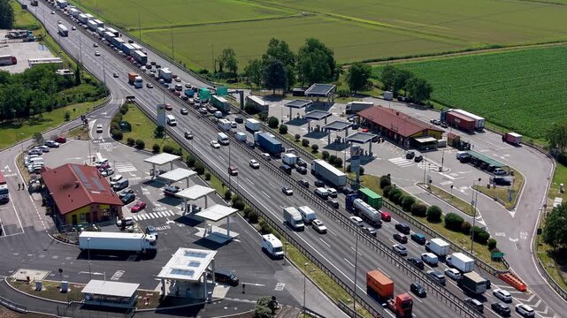 Traffic Congestion at Border Crossing: A vast standstill of trucks and cars at a busy border crossing, highlighting delays and logistical challenges.