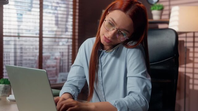 Caucasian business woman typing laptop answering call talking mobile phone busy multitasking girl female businesswoman agent executive work with computer answer smartphone talk communicate in office