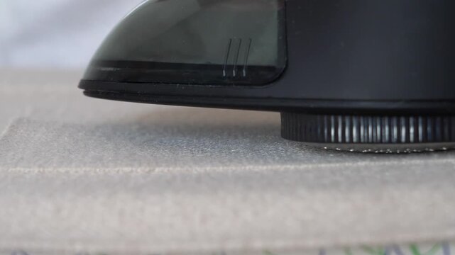 Close up of fabric shaver removes pills from knitted clothing. Textile pilling. Linting. Fabric lint, pilly, pellet, fluff