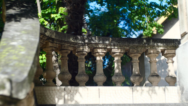 Classical stone balustrade with concrete balusters in the historic old town. Architectural background with classic decorative railing structure on an ancient European building terrace or balcony.
