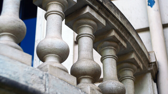 Classical stone balustrade with concrete balusters in the historic old town. Architectural background with classic decorative railing structure on an ancient European building terrace or balcony.