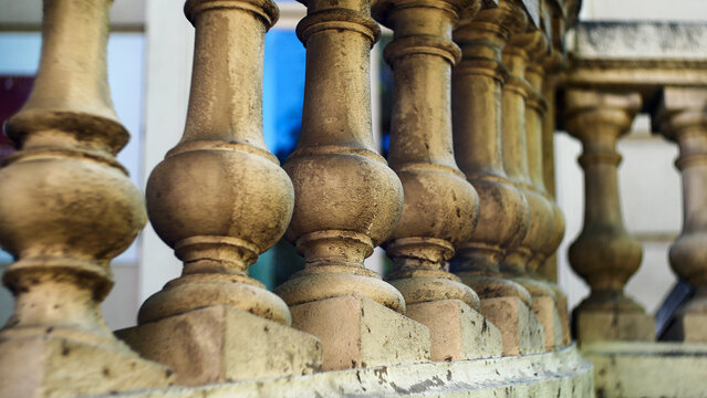 Classical stone balustrade with concrete balusters in the historic old town. Architectural background with classic decorative railing structure on an ancient European building terrace or balcony.