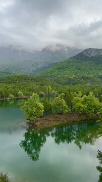Tranquil nature background featuring a calm lake and mountain range