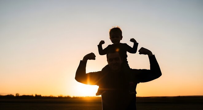 Silhouette of man and child flexing at sunset