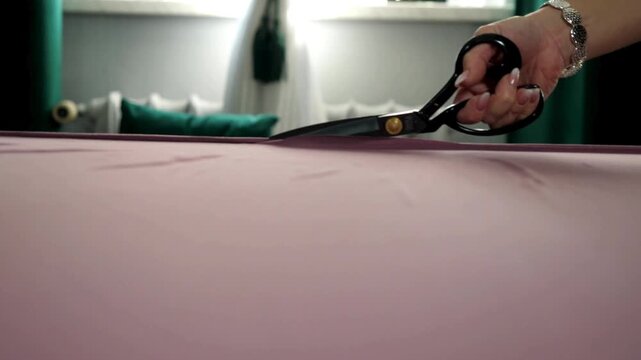 Cutting the textile for a dress seamstress do it precisely and with quality.