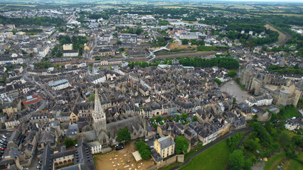 Obraz premium Aerial view beside the old town above the city Vitré in France, on a cloudy noon in early summer.