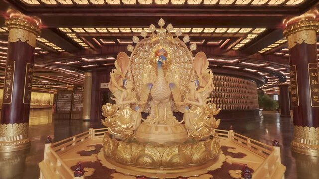 4K resolution static shot of magnificent golden peacock and apsaras statue inside the grand pavilion hall at Donglin Temple scenic area in Jiujiang, shot in ProRes Log format
