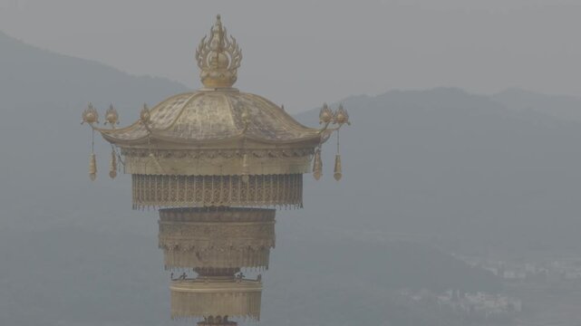 4K resolution cinematic medium shot of the giant golden Amitabha Buddha statue standing inside a flame-shaped architectural arch at Donglin Temple in Jiujiang, China, shot in ProRes Log.