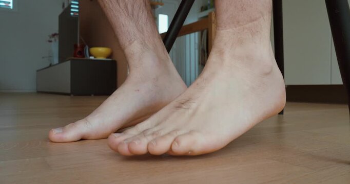 Close-up of restless feet tapping on the floor while sitting. Concept of nervousness, anxiety, impatience, stress, waiting, and body language.