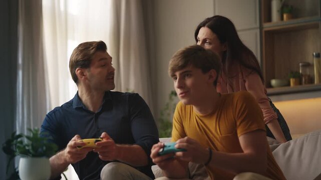 Displeased mother reprimanding teen son and husband for excessive gaming