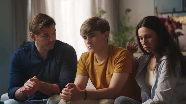 Caring parents comforting and supporting sad teenage son, parental love and care