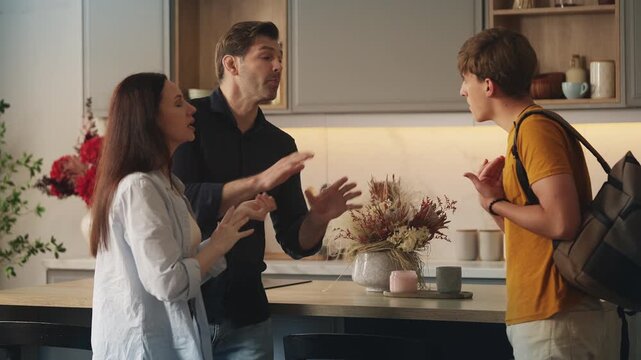 Rebellious teen son arguing with parents, ready to leave home, family crisis
