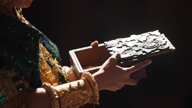 Close-Up of Hand Opening Wooden Jewelry Box Revealing Gold Necklace