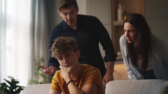 Dissatisfied mother and father shouting at upset teen son, parental pressure