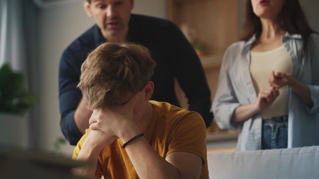 Depressed teenage boy suffering from parental pressure and emotional stress