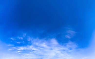 Obraz premium Wide-open sky layered blues from deep cobalt to soft cerulean translucent, drifting clouds along lower plane. Calm and spaciousness, offering a gentle sense of movement and light without overwhelming