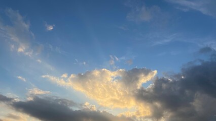 Obraz premium Dramatic Sunlit Cloudscape with Blue Sky Background
