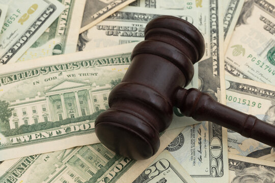 Judge gavel on twenty dollar bills for legal fees and court costs