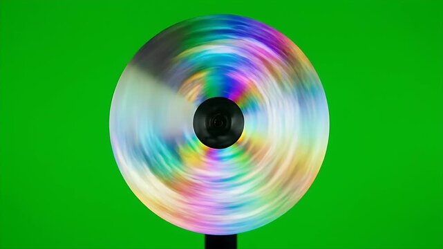 Vivid Spinning Light Disk on Green Screen - A colorful disk spins rapidly against a chroma key green screen background, creating a mesmerizing swirl of vibrant hues.