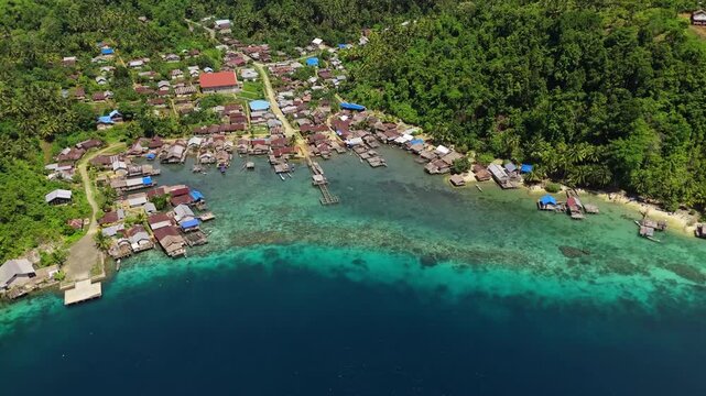 Spectacular drone tracking shot over remote Banggai island coastline &ndash; Beautiful wild paradise beach with pristine sandbars and calm transparent lagoon, unique tropical advertising background