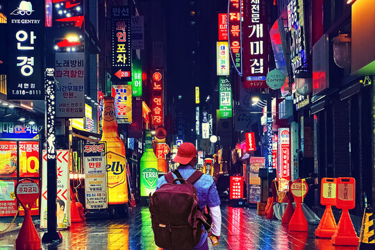 South Korea, Busan - March 30, 2026: A traveler on a city street at night