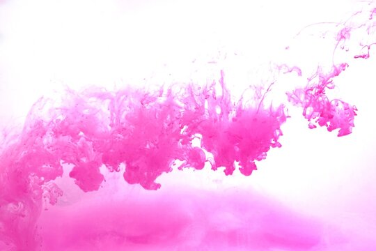 Pink color dye melt on white background,Abstract smoke pattern,Colored liquid dye,Splash paint