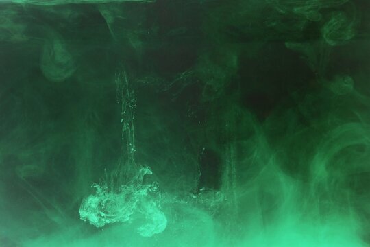Green colorful dye on black background,Art abstract smoke texture,Colored liquid dye,Splash paint,Abstract color,Abstract Textures