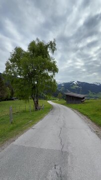 Alpine scenery with old wooden hayloft under high mountains, Leogang, Austria