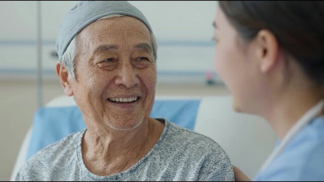 Caring nurse comforting smiling senior cancer patient in hospital.