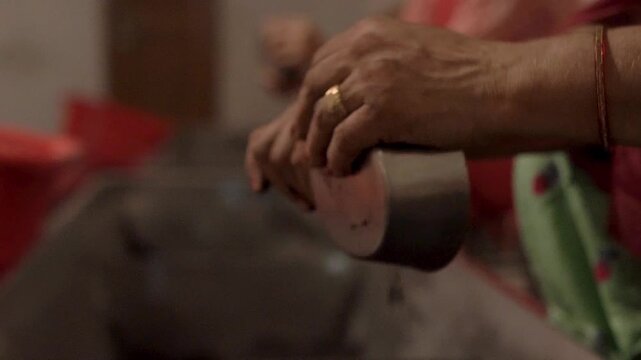Hands cleaning kitchen utensils as part of community seva at Sri Harmandir Sahib.