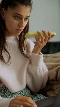 Remote nutritionist prepping lemon wellness shot on laptop