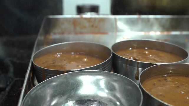 Close up shot of preparing Dal Makhani in traditional Indian dhaba kitchen.