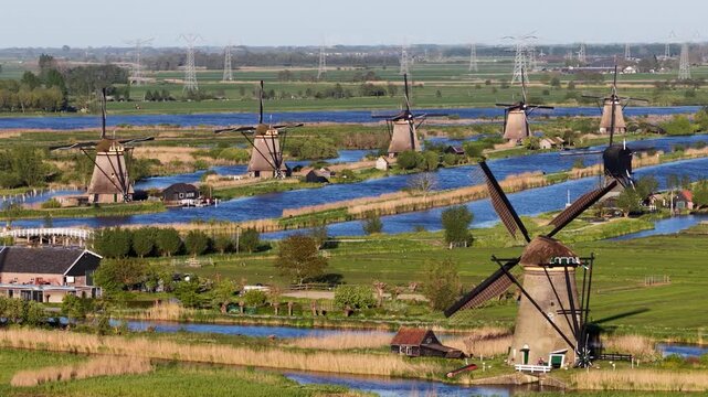 Traditional dutch windmills rotating in kinderdijk polder