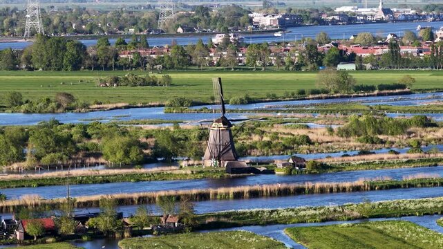 Traditional dutch windmill in kinderdijk polder landscape