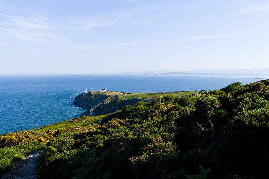 Scenic coastal landscape of Howth Head with the historic Baily Lighthouse on the cliffs, County Dublin, Ireland