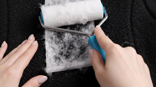Person using lint roller on fabric