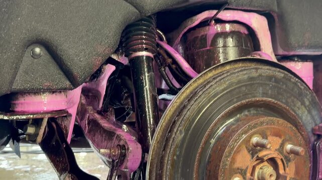 The process of washing the suspension, the underbody of the car with a chemical composition and a brush at the car wash. Washing the suspension of the car from reagents and contaminants using special 
