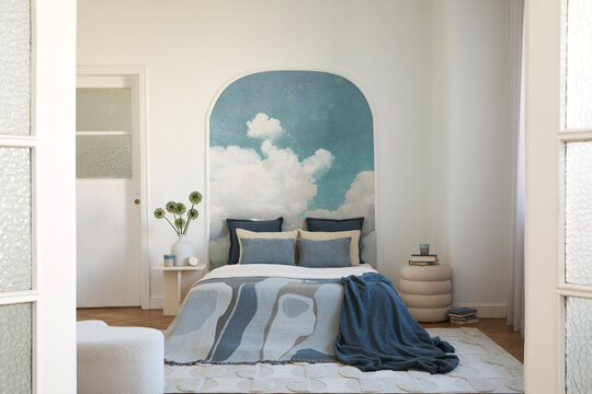 Bedroom Interior with Cloud Mural and Blue Tones: A Serene and Modern Decor Scene for Restful Living Spaces